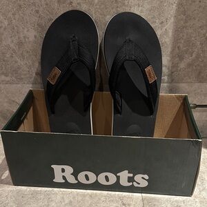 Roots Black and White Flip Flops